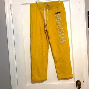 Yellow sweatpants with flared bottoms.